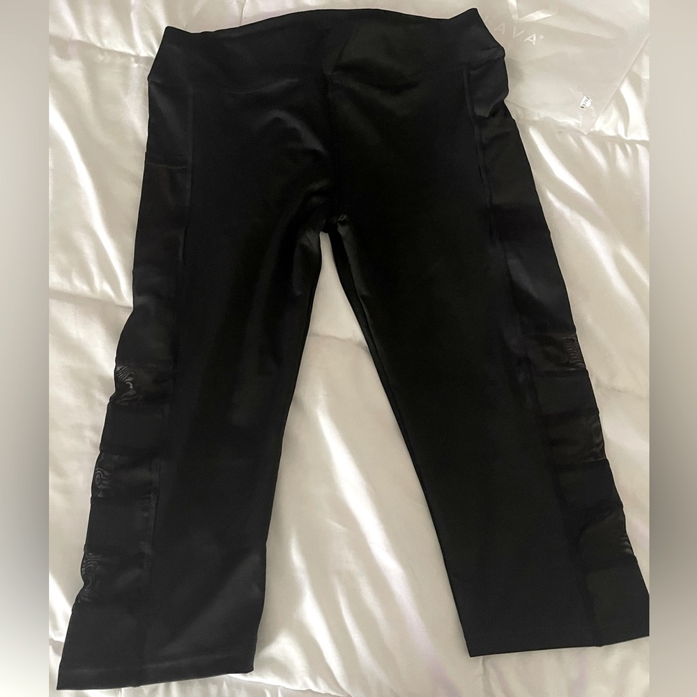 Brand new with tags size medium black yoga pants w/shear see through on legs.